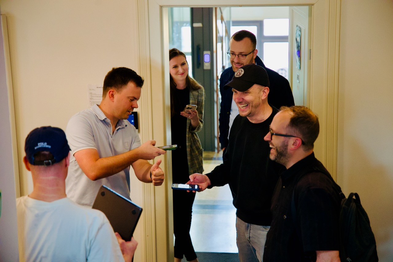 A candid moment at the doorway as people arrive